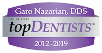 The image shows a logo with text that reads GARO NAZARIAN, DDS followed by the words TOPDENTISTS 2013-2019 SELECTED, and below that, there s a purple background with white text stating TOPDENTISTS . The logo is accompanied by a badge or emblem with the same name TOPDENTISTS in a stylized font.