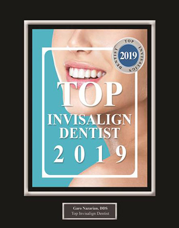 The image displays a framed certificate with text that reads TOP INVISALIGN DENTIST 2019 along with the name CareNations Dental Clinic at the bottom, indicating an award for excellence in invisible braces treatment for the year 2019.