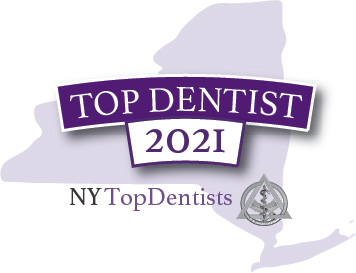 The image features a graphic logo with text elements, including the name TOP DENTIST 2021 prominently displayed at the top, followed by the word NYTOPDENTISTS in smaller font below it. A stylized map icon of New York State is visible to the left side of the image, and there s a designation that reads NEW YORK TOP DENTISTS in capital letters beneath the state icon. The overall style of the image is professional and appears to be an emblem or award related to dentistry for 2021, specifically in New York State.