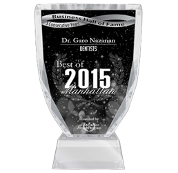 The image shows a clear acrylic award stand with a plaque on top, featuring text and a graphic element, placed against a dark background with a starburst effect.